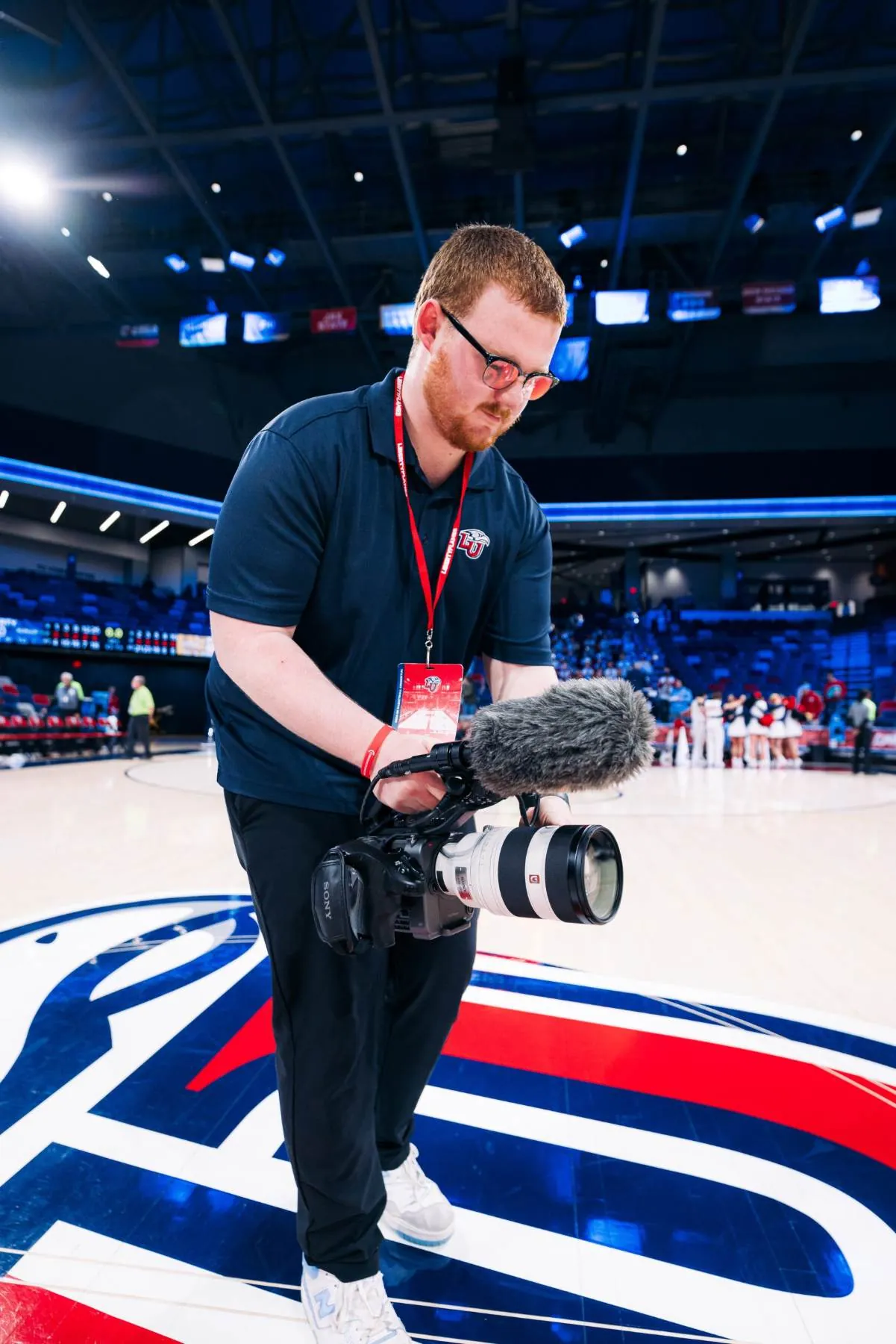 Jesse filming courtside with a cinema camera